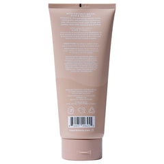 Kopari Tahitian Vanilla bottle on a shower shelf signaling vegan, cruelty-free cleanse.