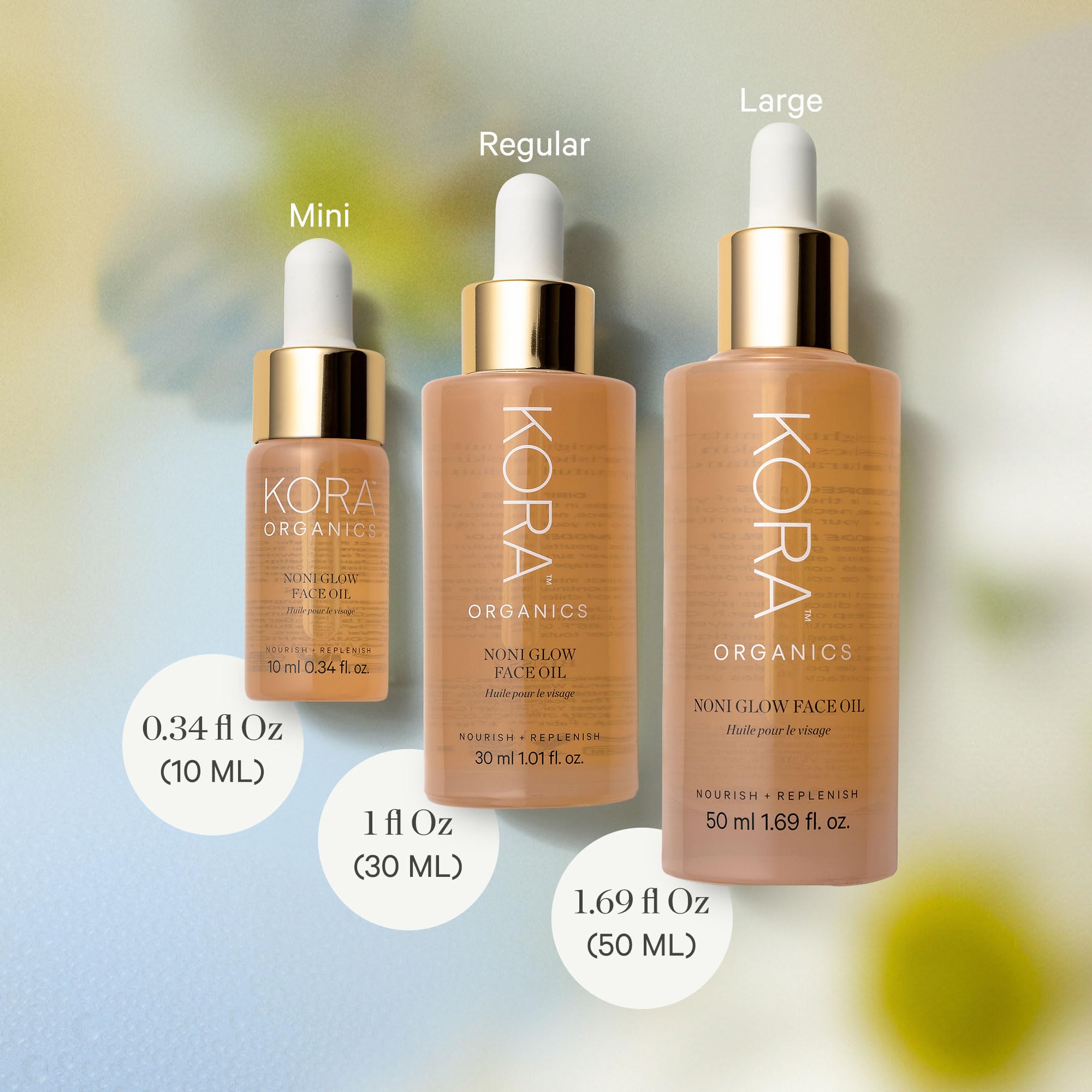 KORA Organics Noni Glow in-action applying oil on skin.