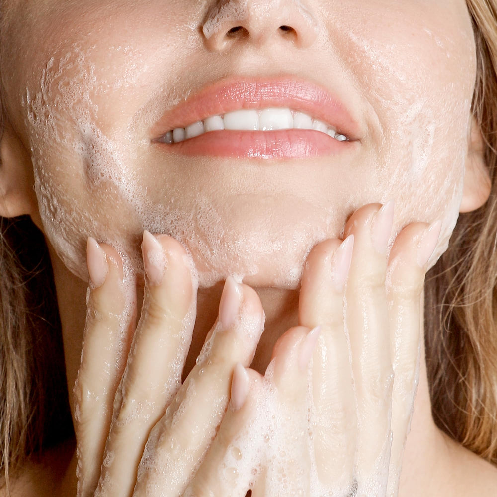 KORA Organics Turmeric Glow Foaming Cleanser water rinse demonstrates gentle rinse-off experience.
