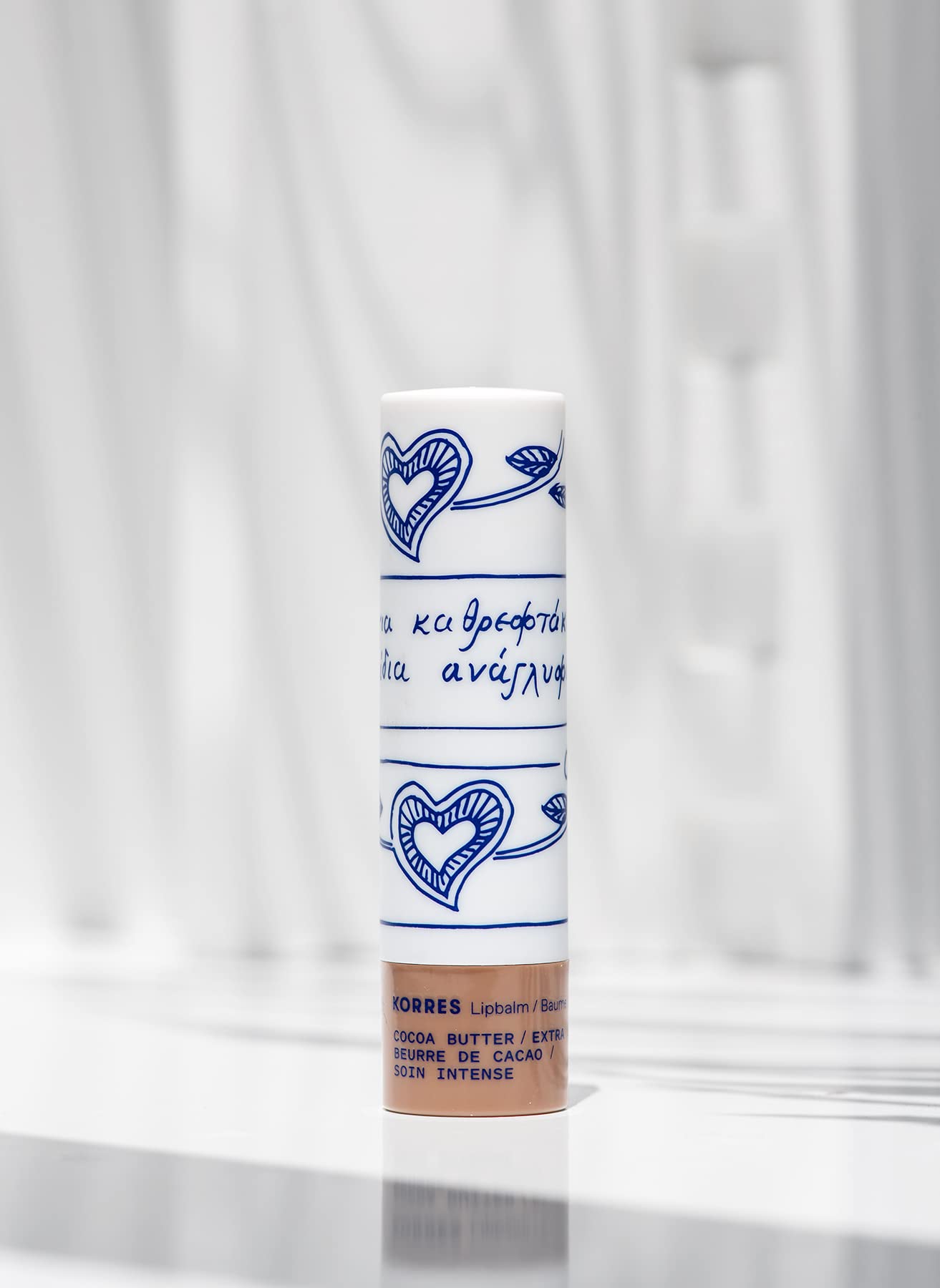 KORRES Lip Butter Stick applied on lips showing subtle tint.
