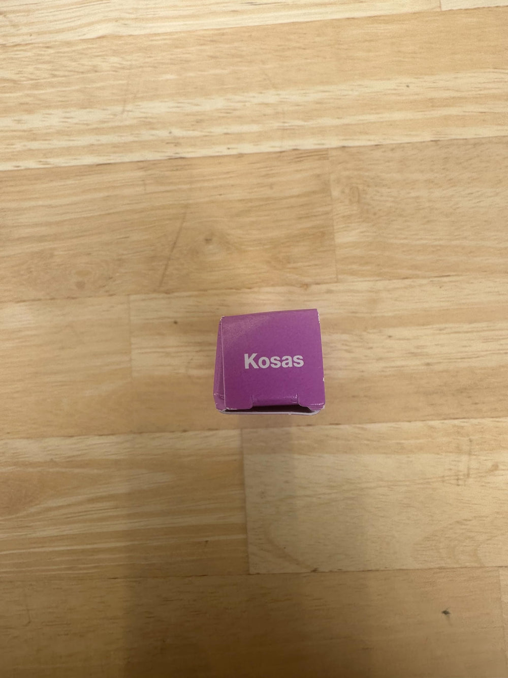 Kosas Air Brow Tinted Gel tube beside clean beauty branding