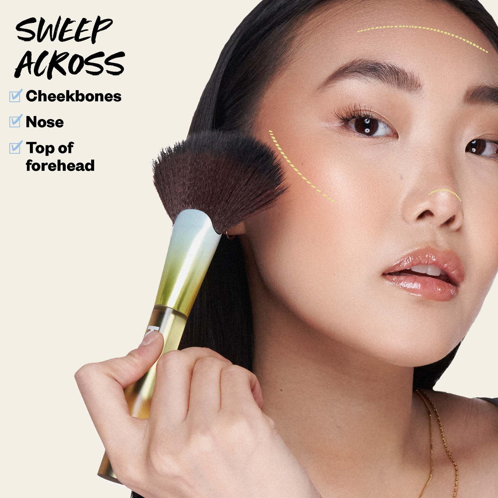 Kosas Sun Show Glowy Warmth on cheekbones demonstrates natural, subtle glow.