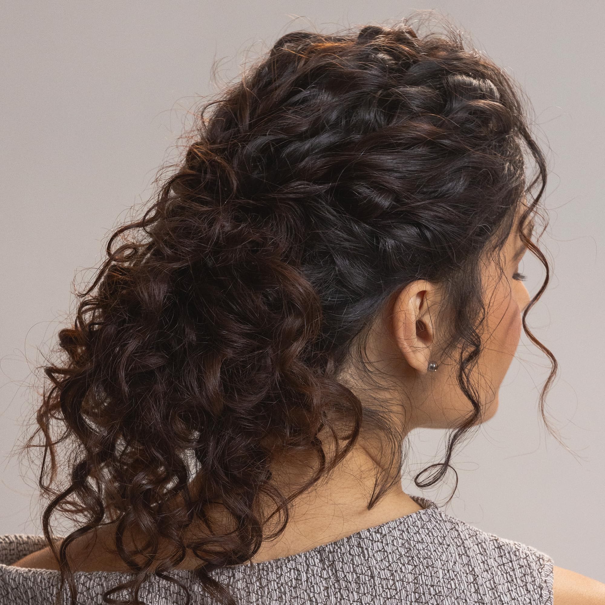 Kristin Ess curl leave-in cream application scene highlighting detangling during styling.