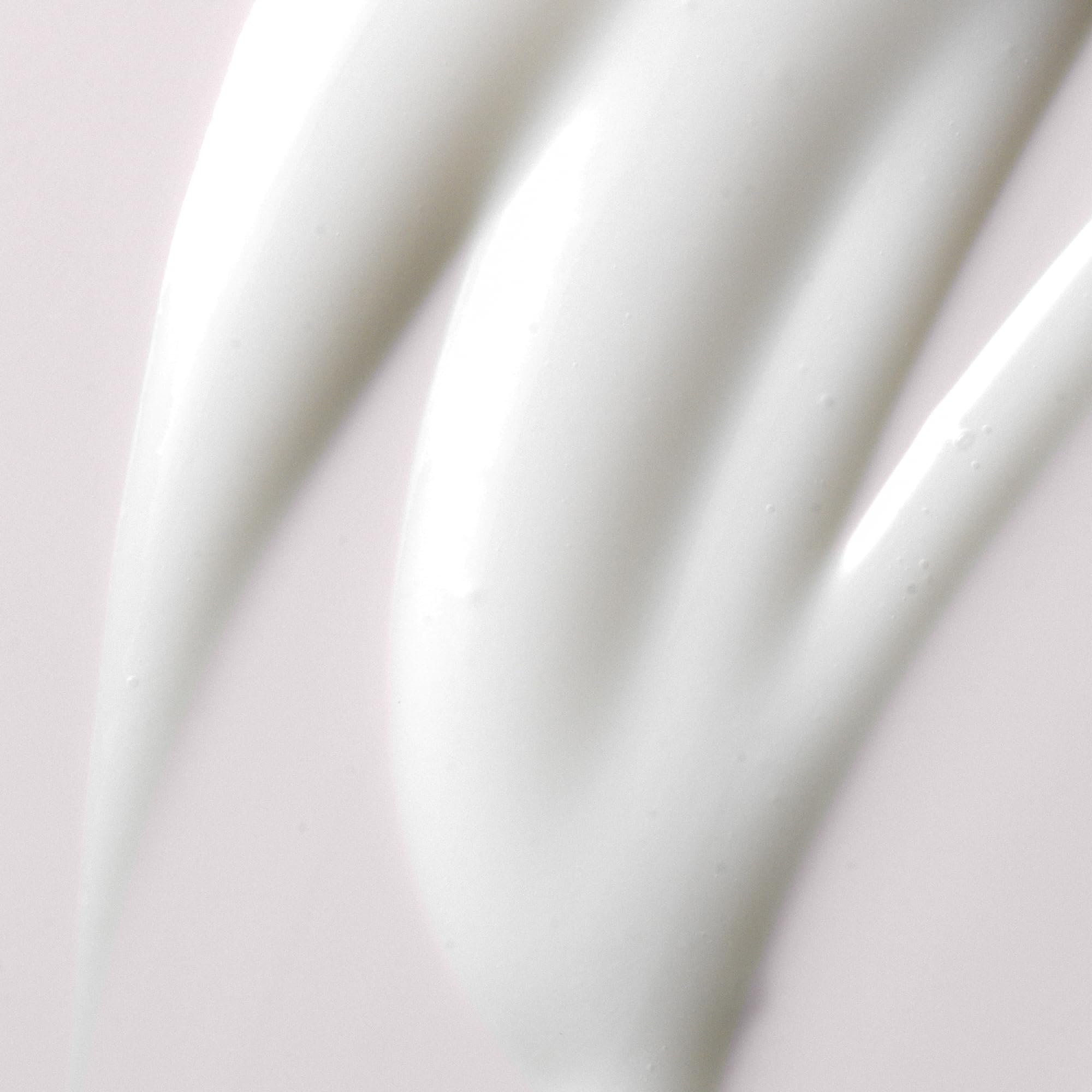 Kristin Ess Ultra Hydrating Curl Leave-In Cream on model's curls showcases added shine after use.