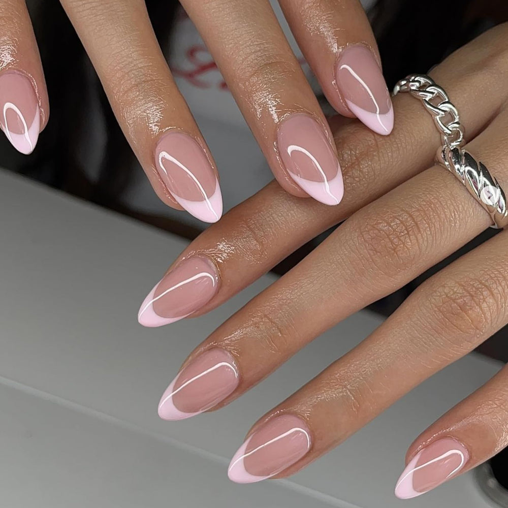 KXAMELIE light pink French-tip short almond nails closeup with glossy salon-like finish