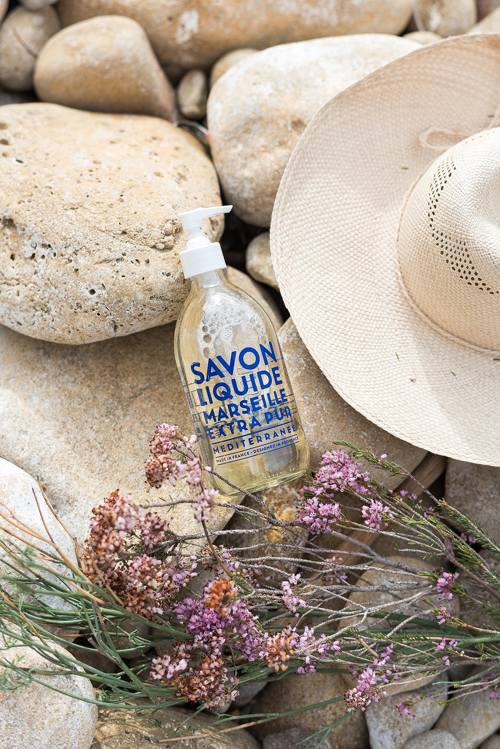 La Compagnie de Provence glass bottle glows in sunlight for premium use.