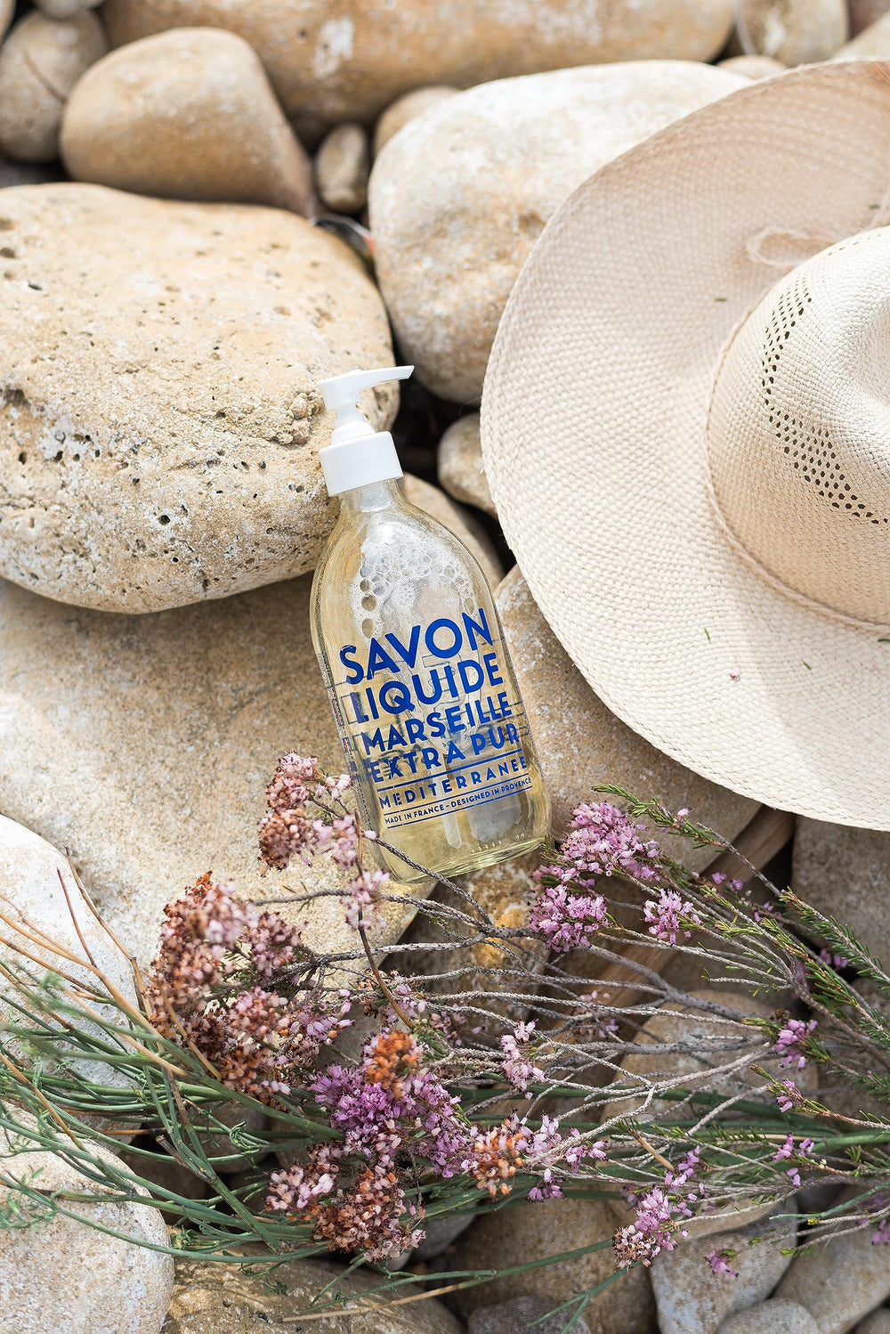 La Compagnie de Provence glass bottle glows in sunlight for premium use.