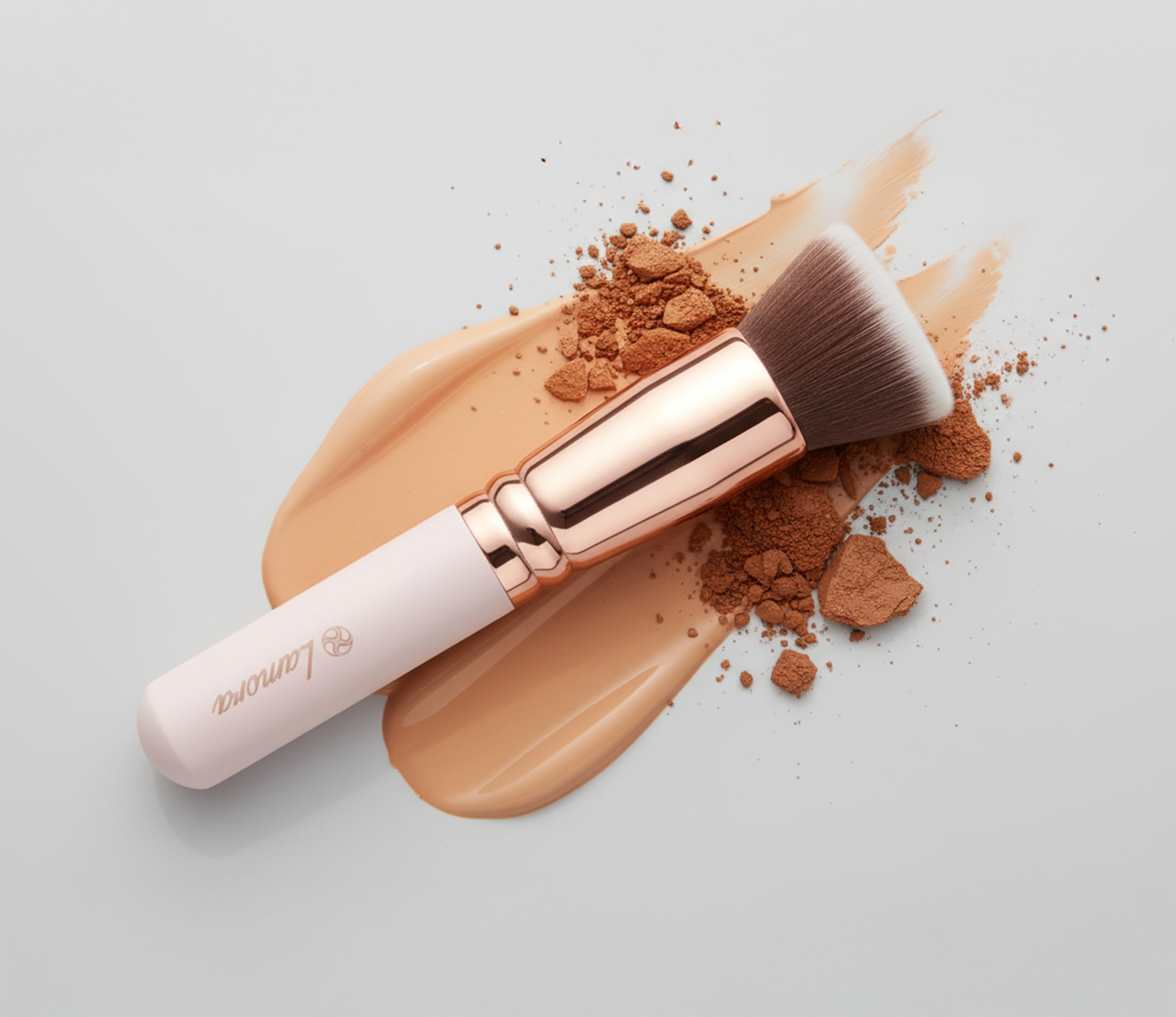 Lamora brush blending cream to powder textures for seamless application.