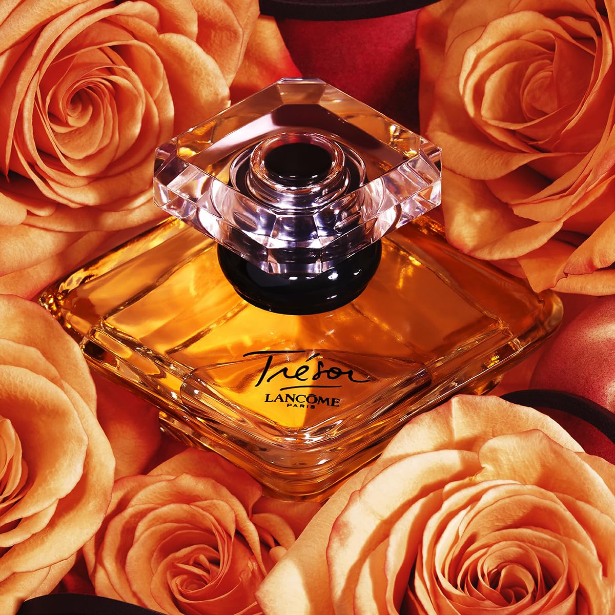 Lancôme Trésor crystal pyramid bottle with gold cap.