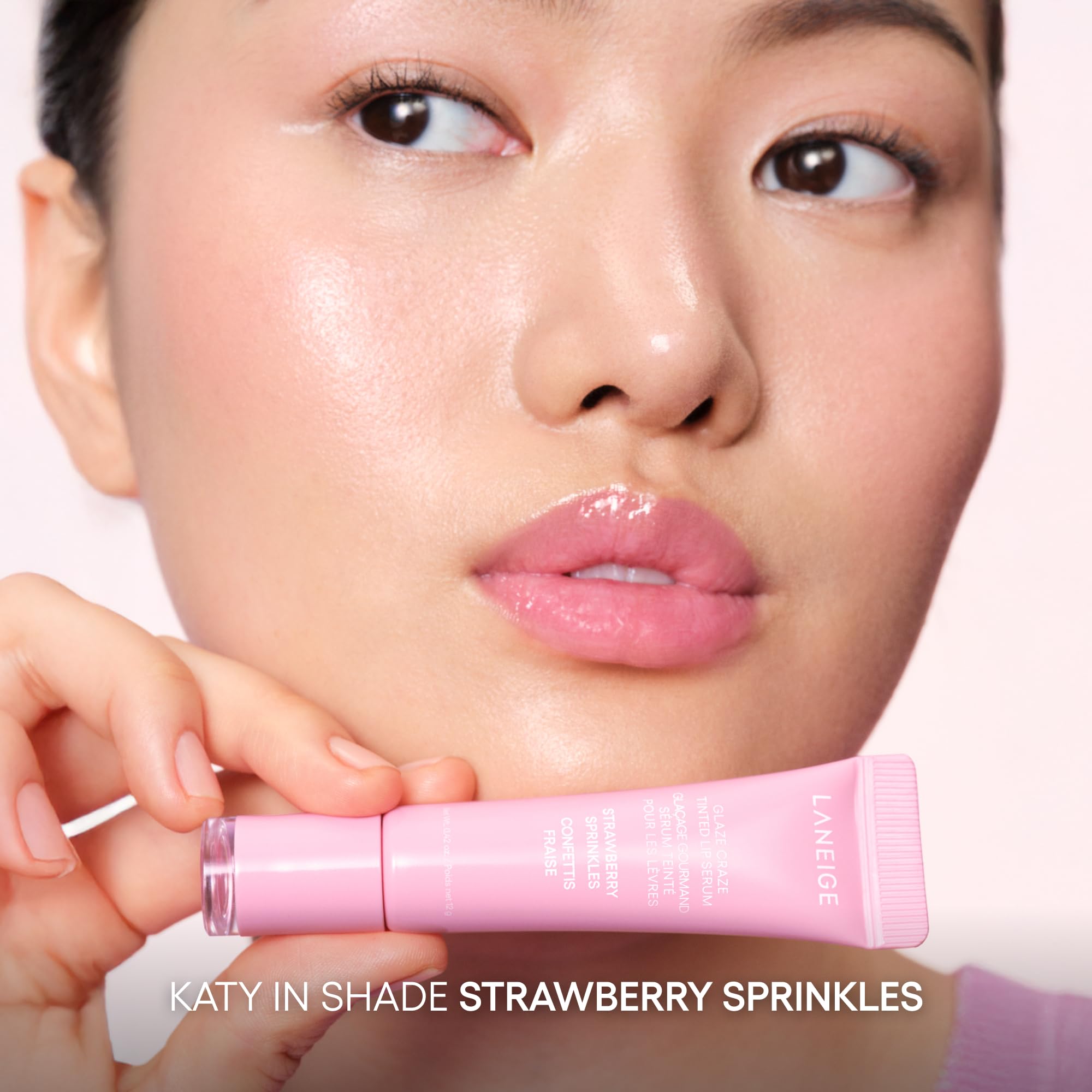 Application demonstration of lip serum over color for added shine.
