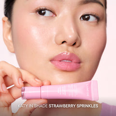 Application demonstration of lip serum over color for added shine.