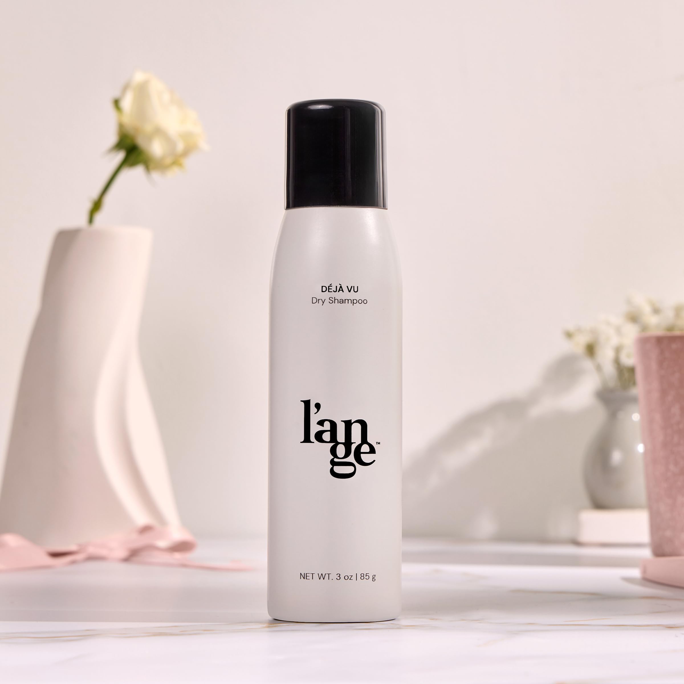 L'ANGE HAIR Deja Vu dry shampoo bottle in-use showing quick refresh between washes.