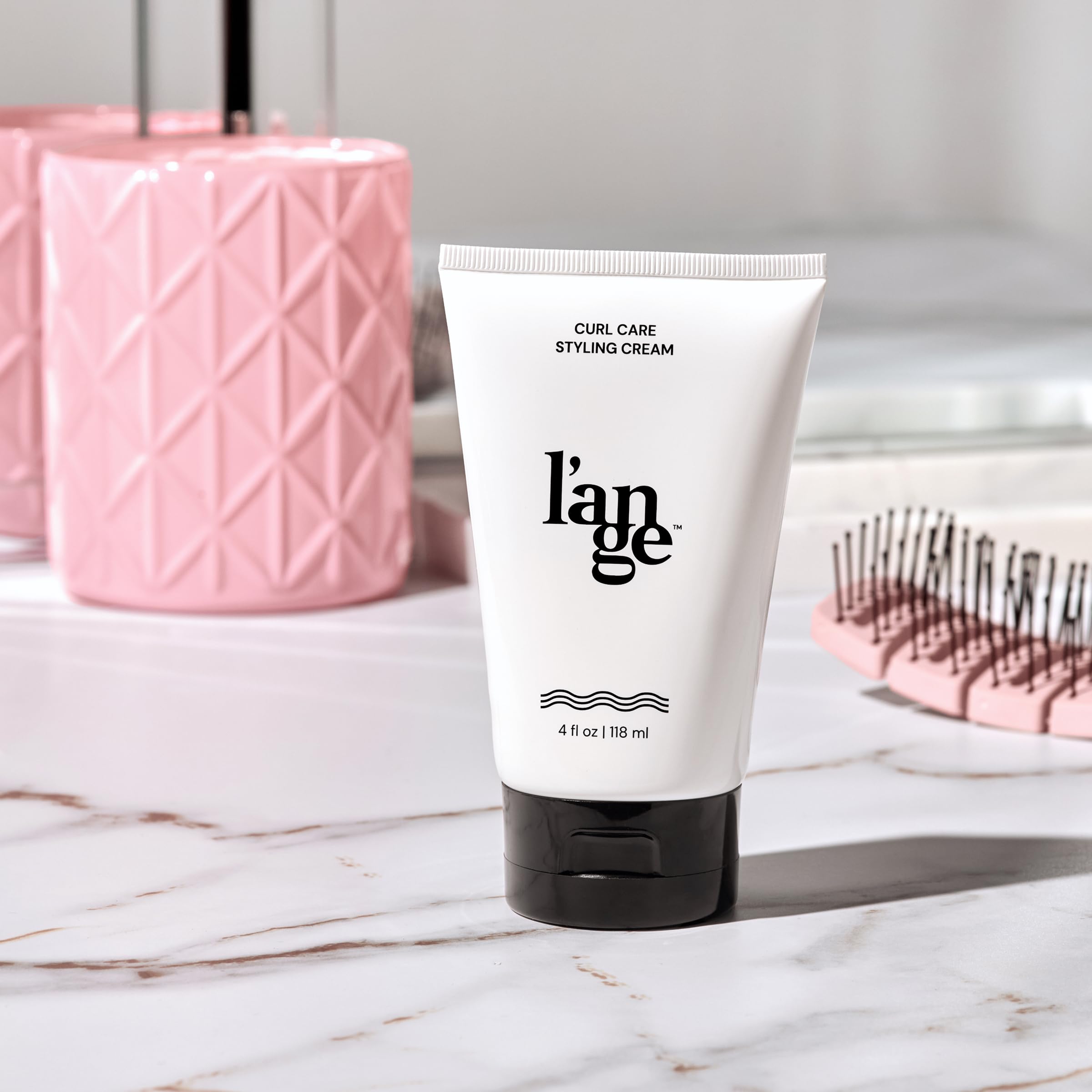 L'ANGE Hair Styling Cream 8 oz jar on bathroom vanity ready for styling.