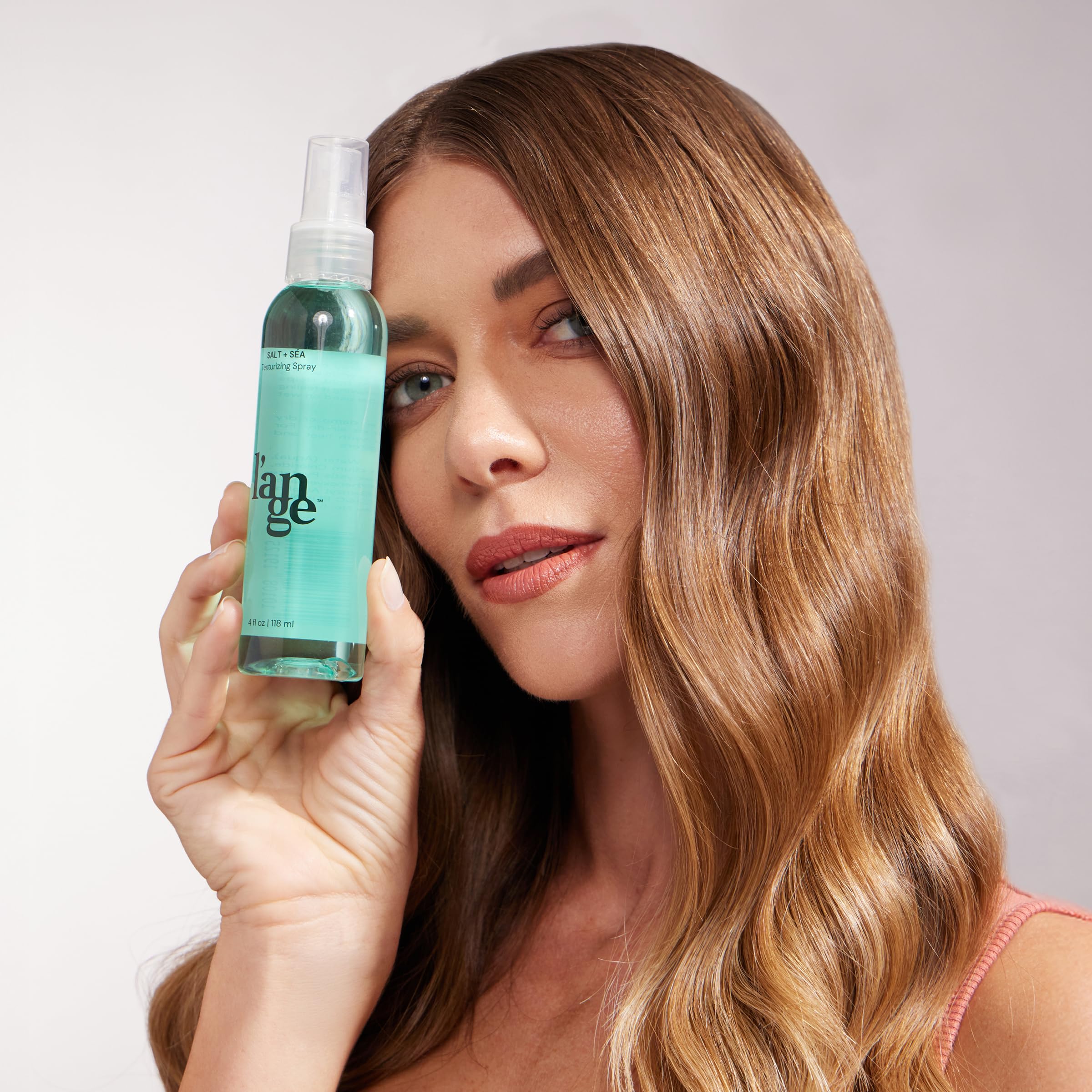 L'ANGE HAIR Sea Salt Texturizing Spray hair texture shows lifted roots and definition.