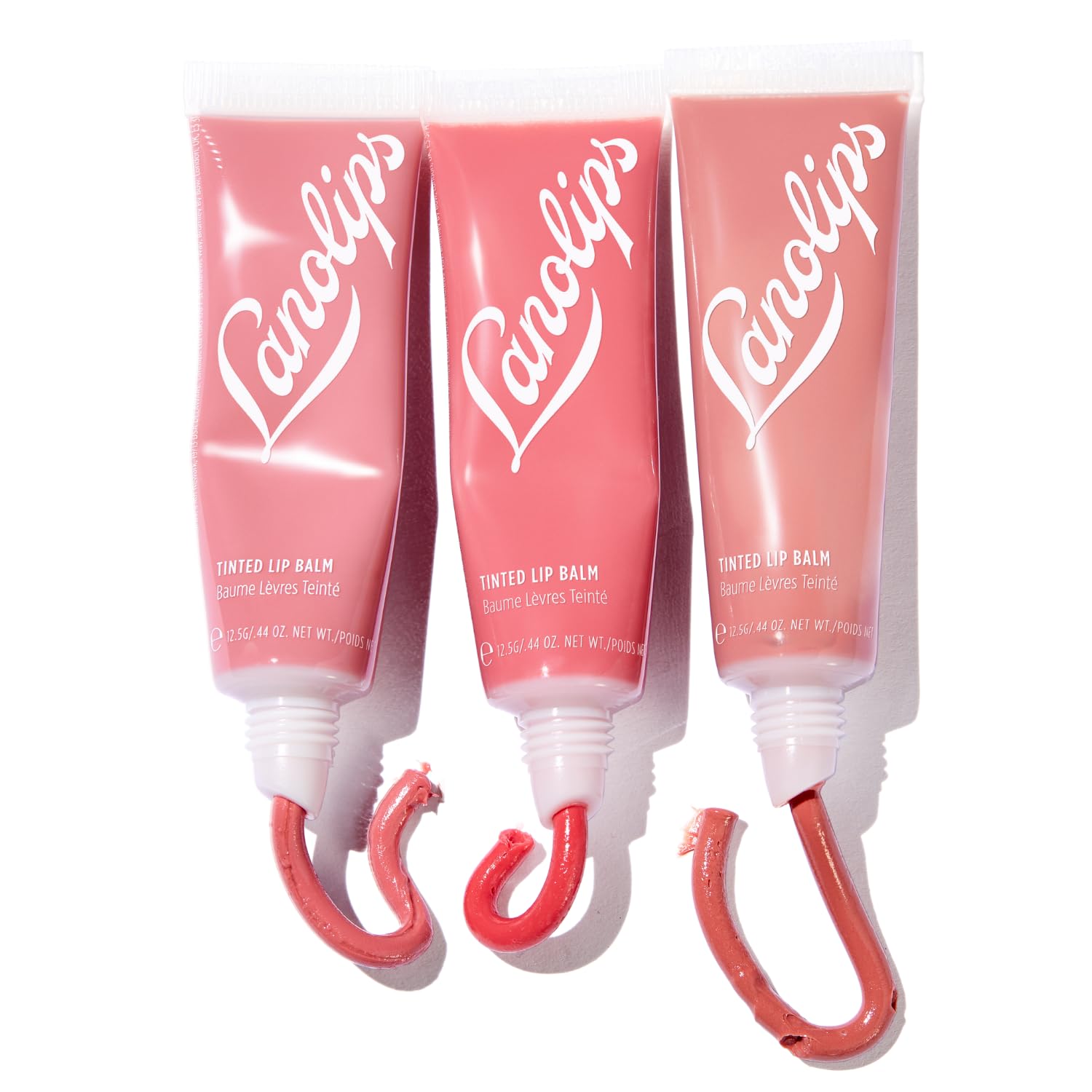 Lanolips Essentials Lip Tint Rhubarb swatch highlights a pink berry glow that enhances natural color.