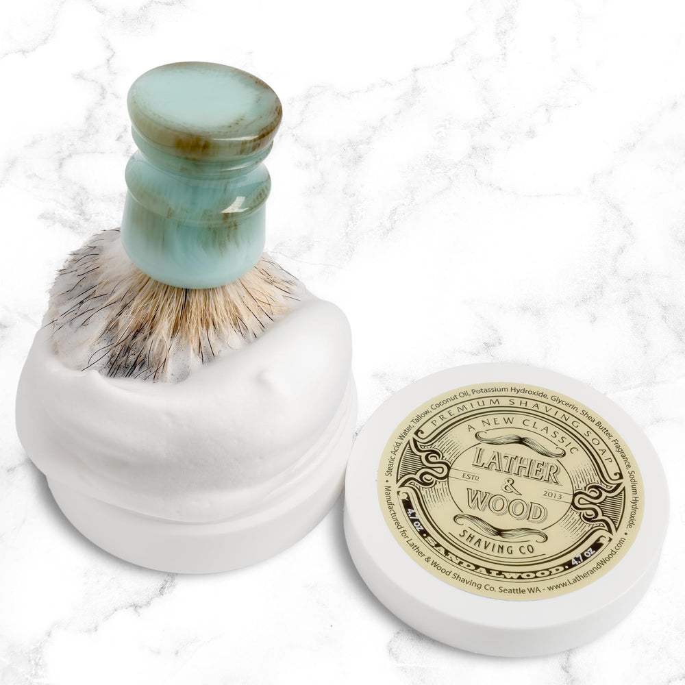 Shaving brush and razor beside Sandalwood soap setup.