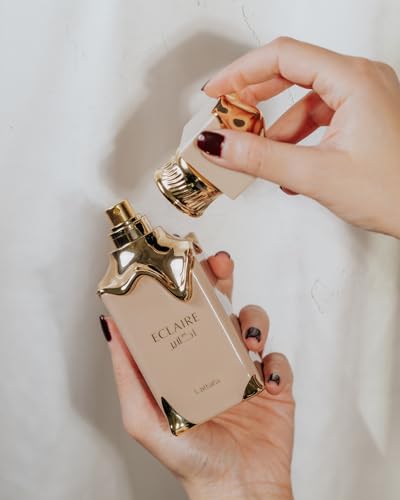 Lattafa Eclaire perfume bottle spray on a sleek flacon display
