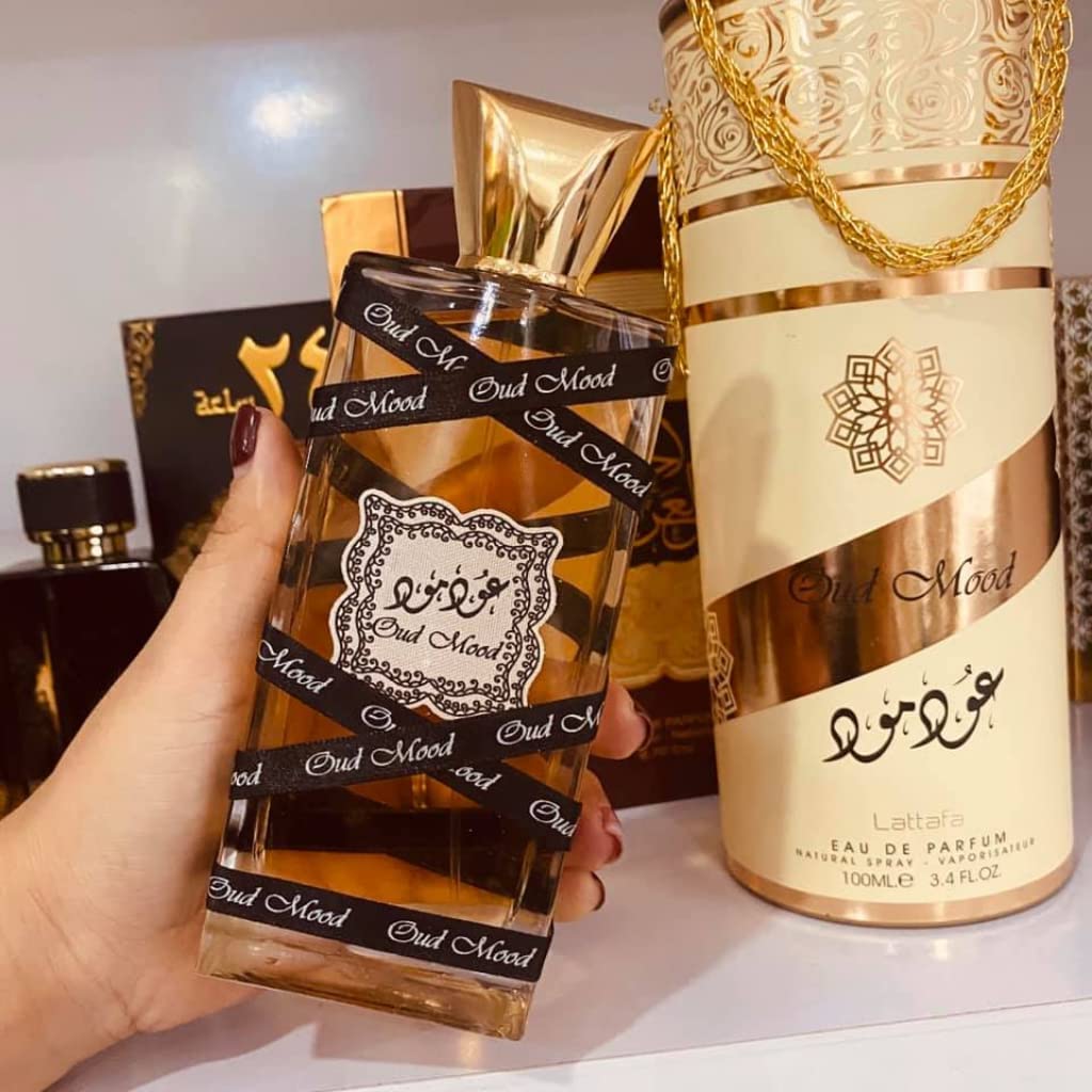 Lattafa Oud Mood heart notes image emphasizes amber and resins for warmth.