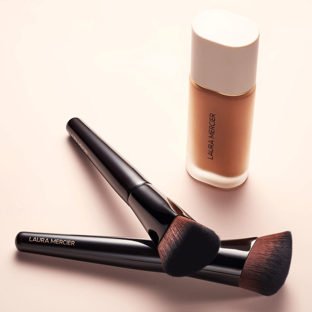 Laura Mercier Real Flawless Foundation Brush hand-application in action delivering skin-like finish.