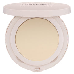 Laura Mercier Ultra-Blur powder compact closeup shows smooth texture and translucent finish.