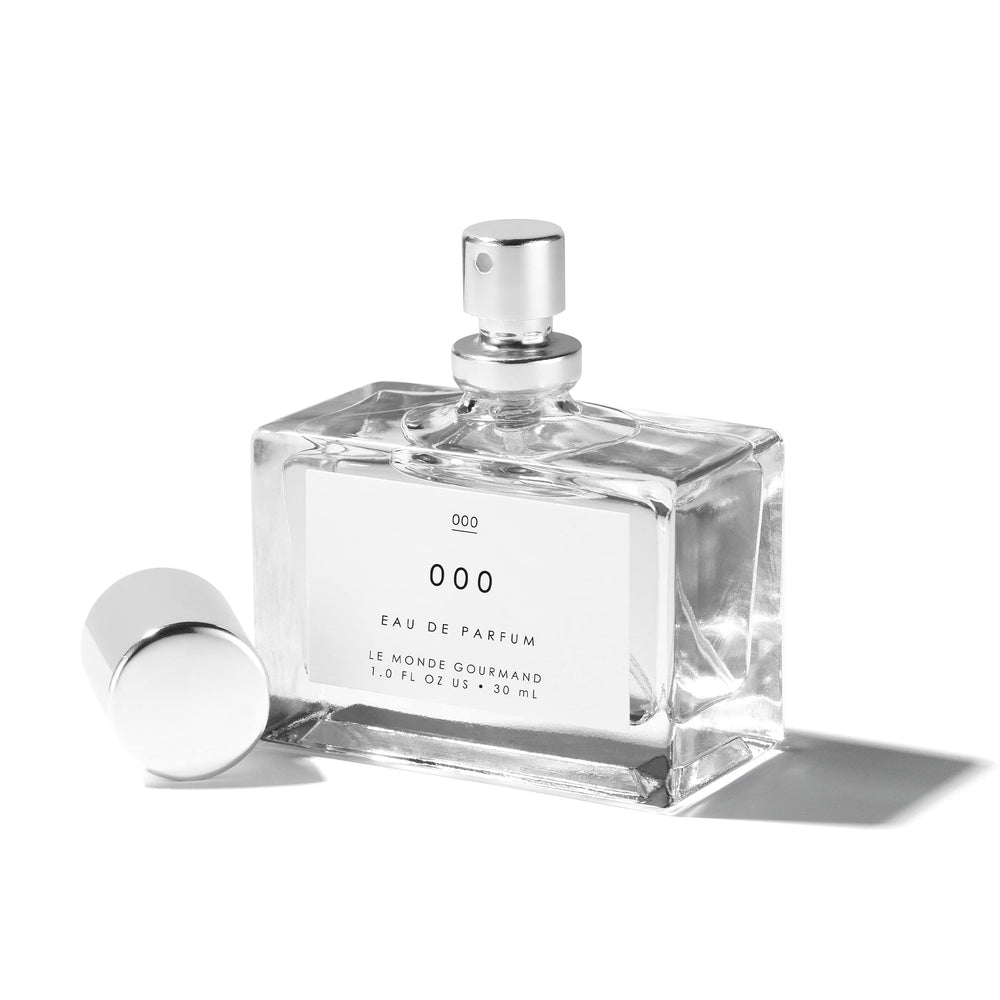 Le Monde Gourmand 000 Spray on vanity shows pulse-point wear for lasting fragrance.