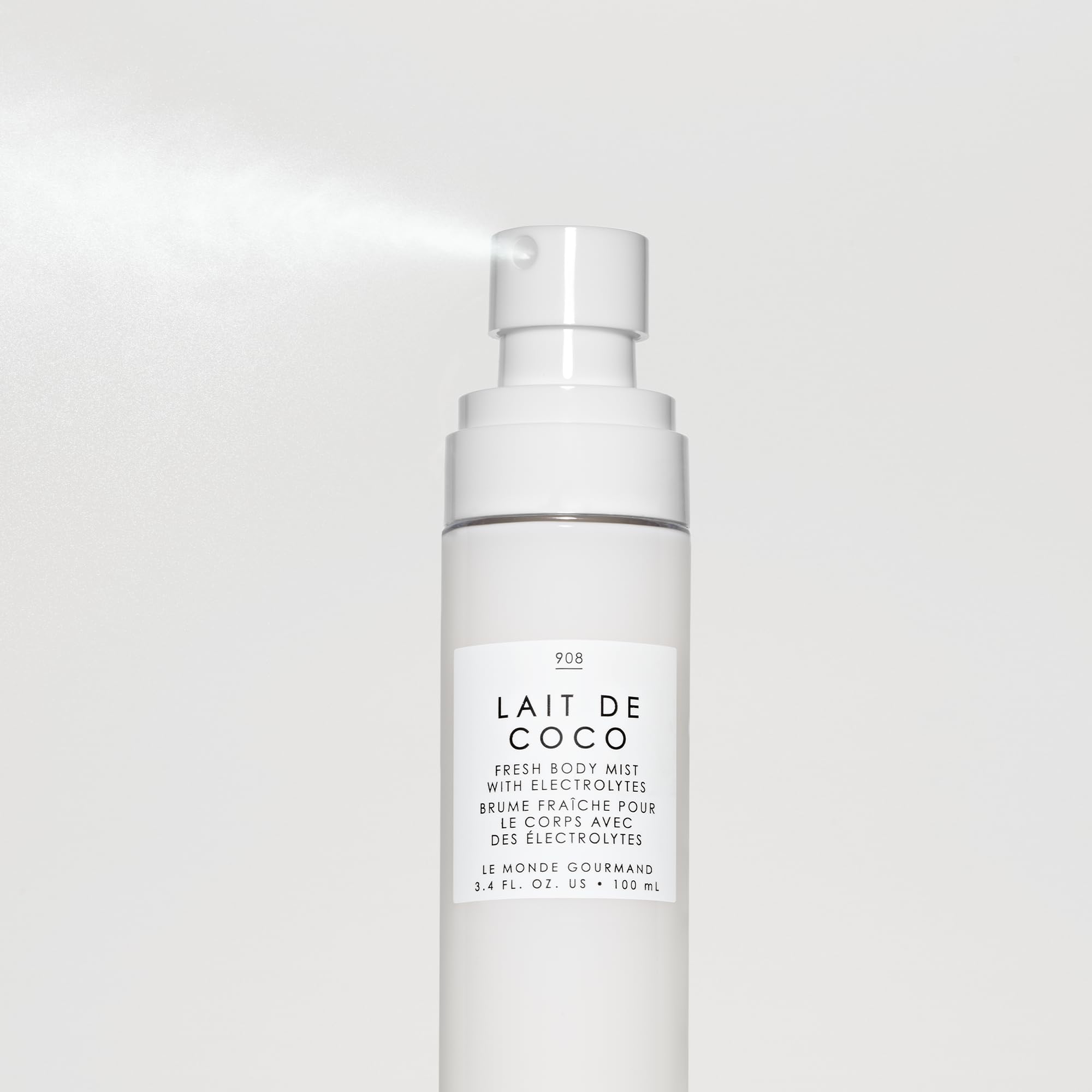 Soft mist applied to the skin, conveying a breezy tropical moment and quick refresh.