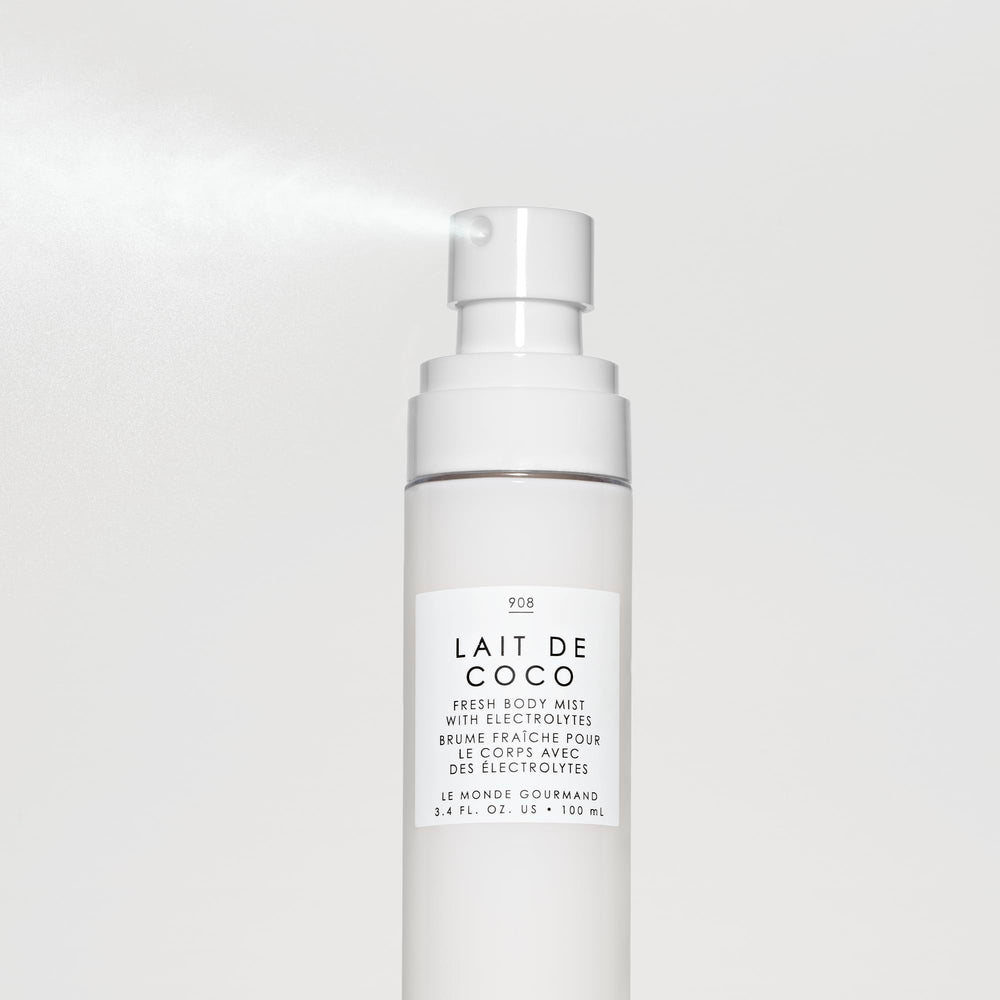 Soft mist applied to the skin, conveying a breezy tropical moment and quick refresh.