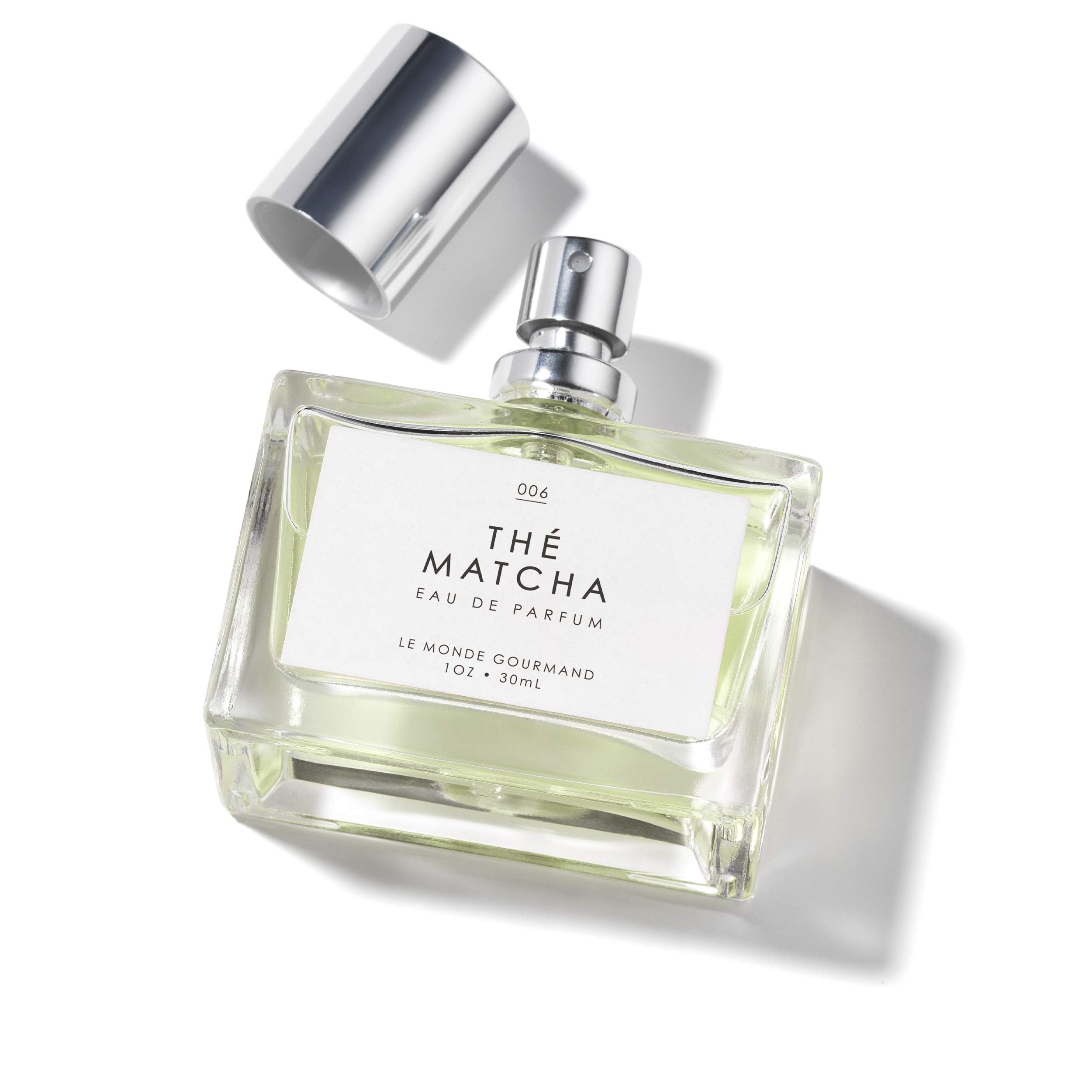 Le Monde Gourmand Thé Matcha displayed on a dresser with other fragrances for a versatile wardrobe.