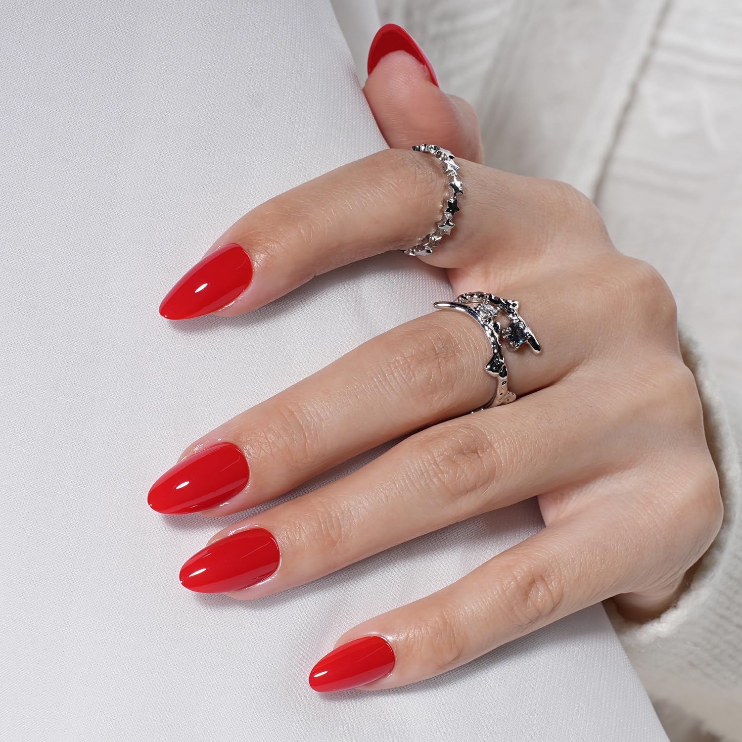 Close-up of Leefrei Red Press On Nails glossy almond tips for a natural look