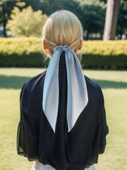 LFOUVRE satin hair scarf closeup shows glossy fabric and knotted bow detail