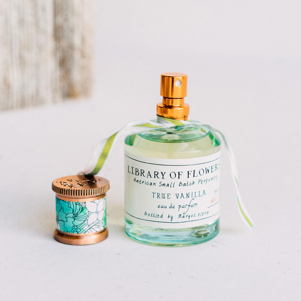Library of Flowers True Vanilla EDP close-up highlighting the luxe glass bottle.