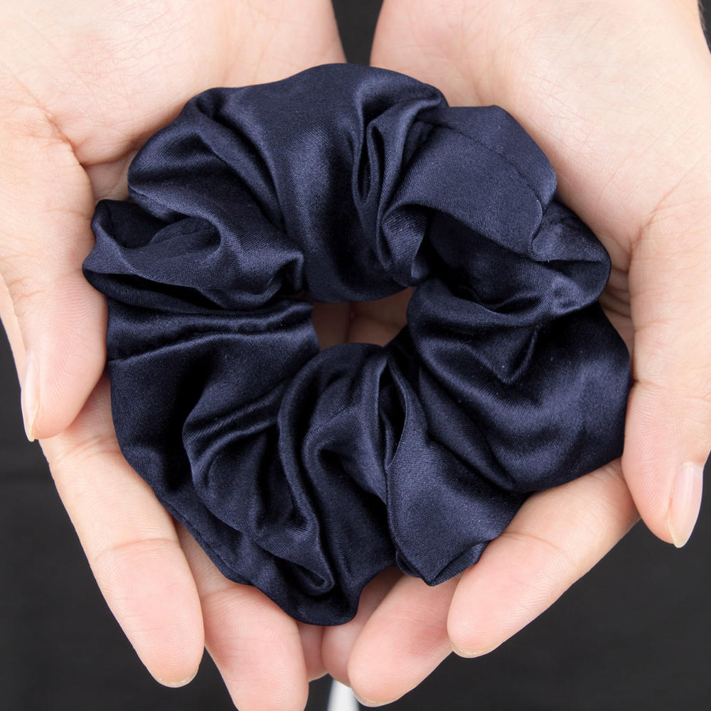 LilySilk navy scrunchie on wrist demonstrates daily accessory that helps protect hair