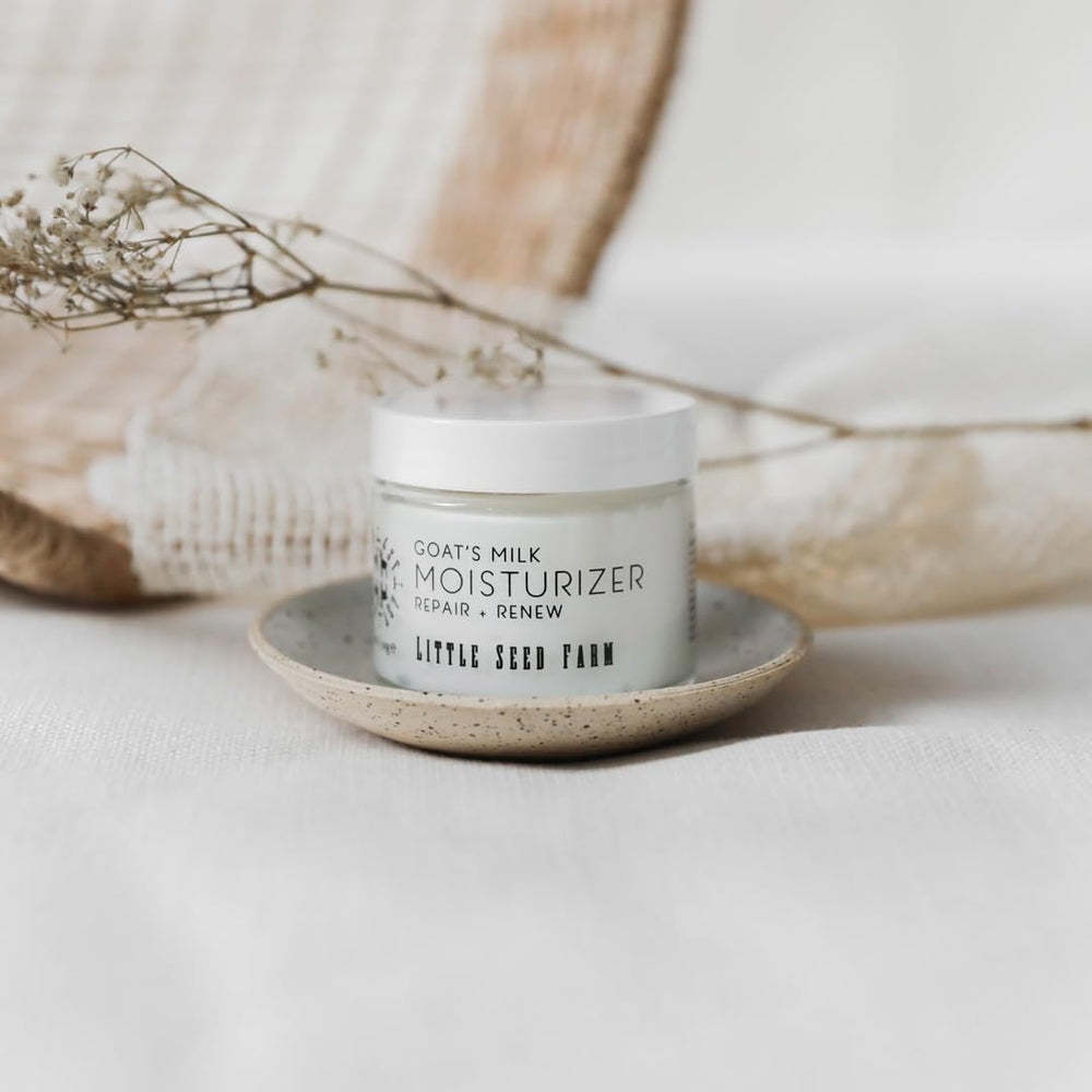 Little Seed Farm goats milk face moisturizer glass bottle highlights natural ingredients for gentle daily hydration.