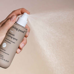 Living Proof No Frizz Smooth Styling Spray humidity-protection scene suggests long-lasting smoothness.
