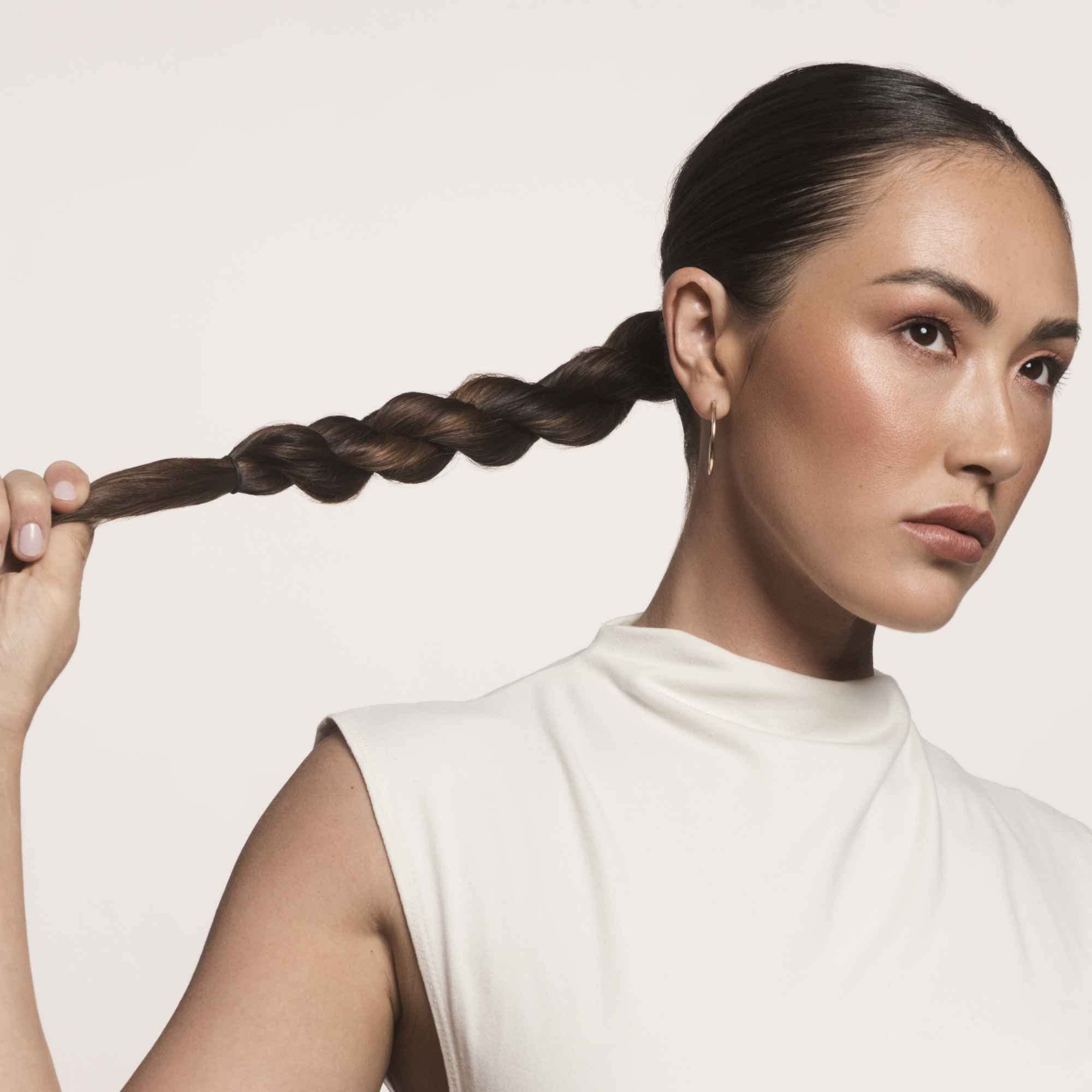 Living Proof No Frizz Smooth Styling Spray urban-styling shot emphasizes controlled, flexible hold.