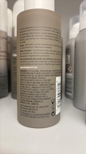Living Proof No Frizz Vanishing Oil applied to hair on hands