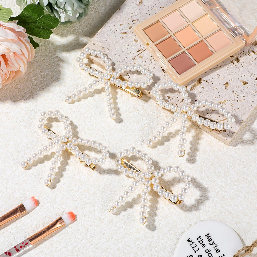 LLOUSSAK Pearl Bow Clip clipped into a ponytail for chic styling.