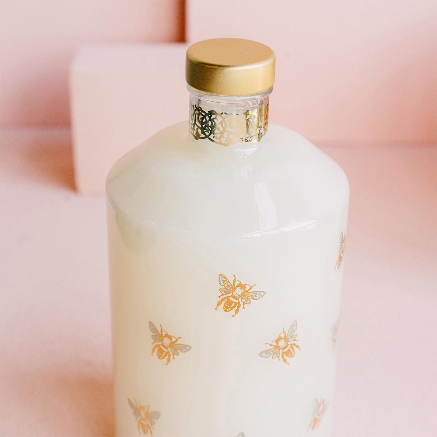 LOLLIA Wish Bubble Bath glass decanter bottle with golden bees showcases luxe packaging