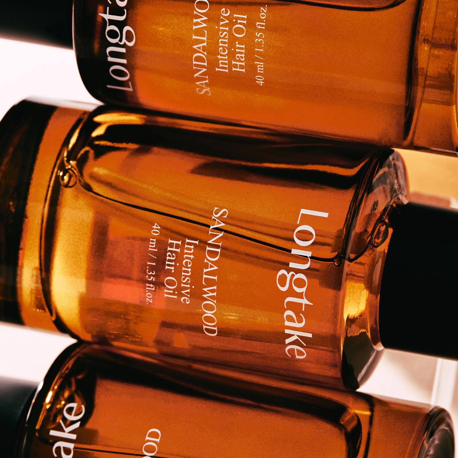 LONGTAKE Hair Oil on damp hair demonstrates detangling and lightweight feel.