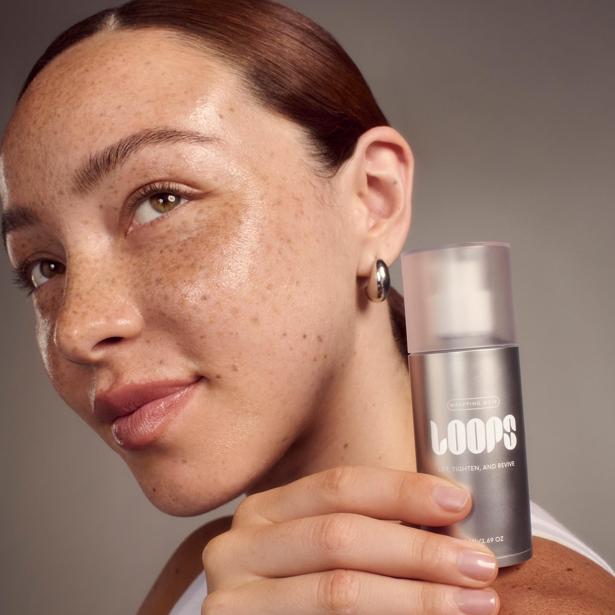 LOOPS Wrapping Mask bottle closeup showcasing luxury serum formulation for lifting