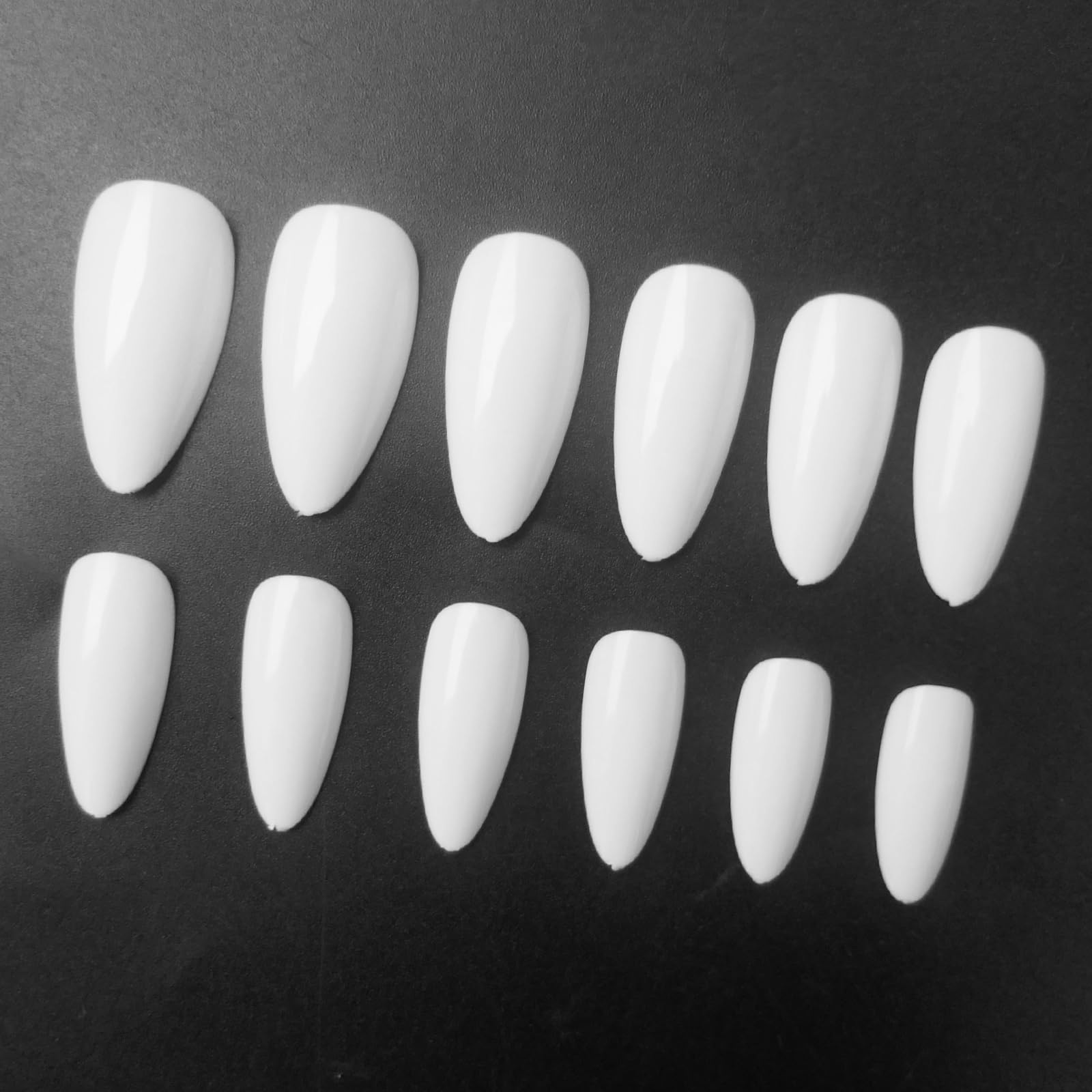 LoveOurHome stiletto almond nails close-up for a bold chic look.