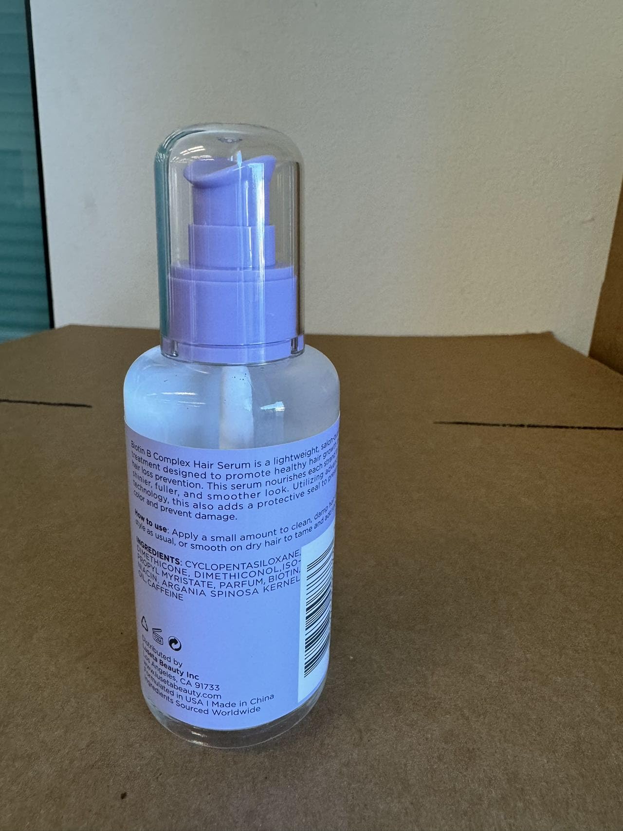 Luseta Biotin B-Complex Hair Oil applying on hair strand for hydration