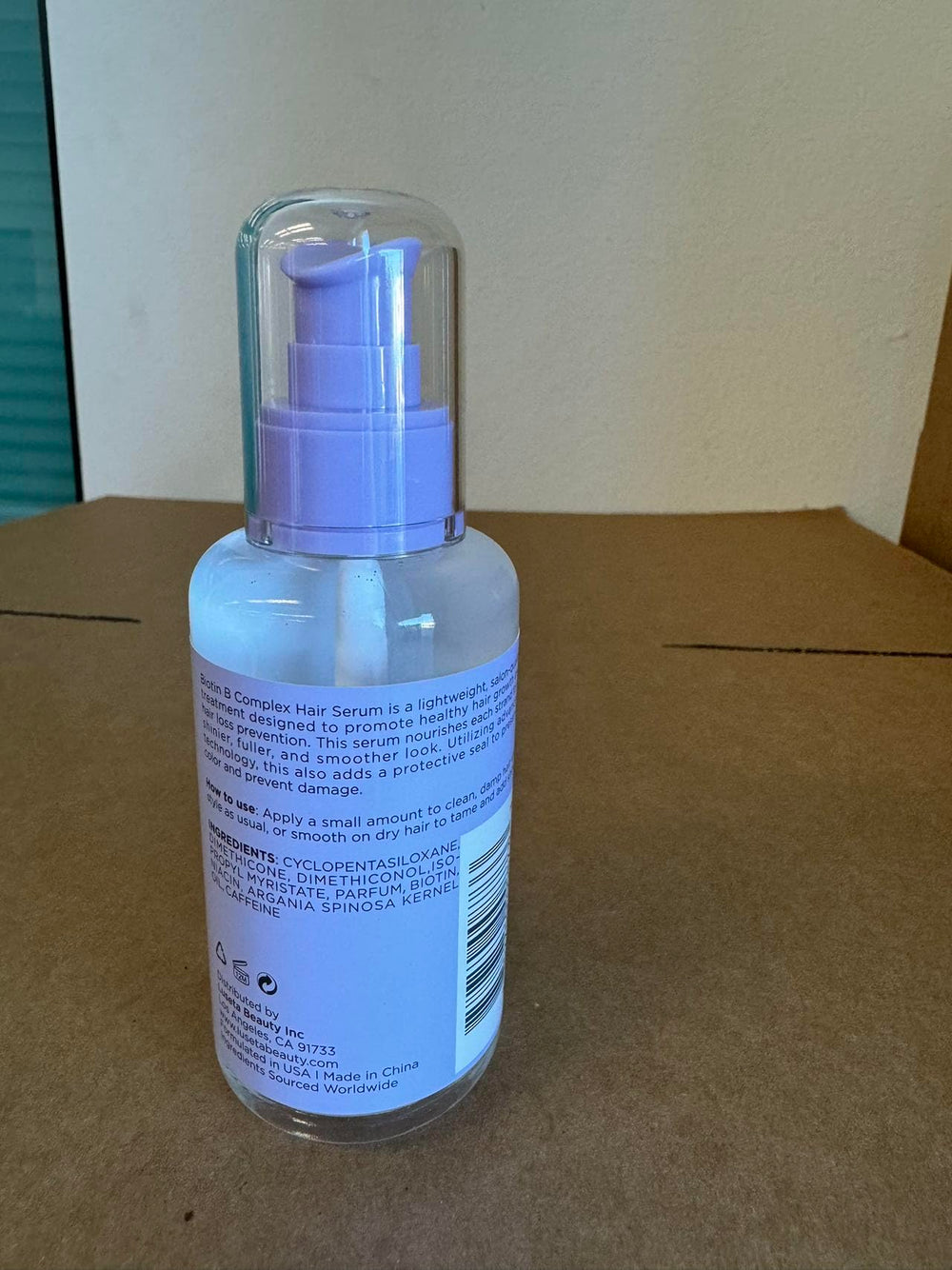 Luseta Biotin B-Complex Hair Oil applying on hair strand for hydration