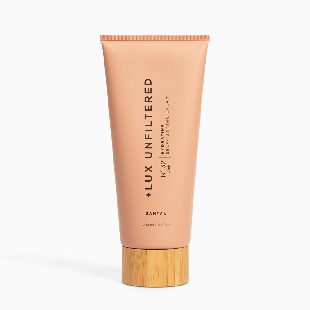 Lux Unfiltered N°32 bottle closeup showcasing hydrating sunless tan with buildable glow