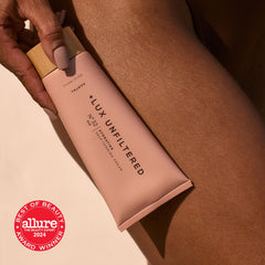 Lux Unfiltered N°32 gradual-tan application on arm demonstrating buildable color
