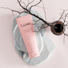 Luxe Cosmetics Hair Growth Shampoo in daily-use lather scene suggesting nourishment for thicker hair.