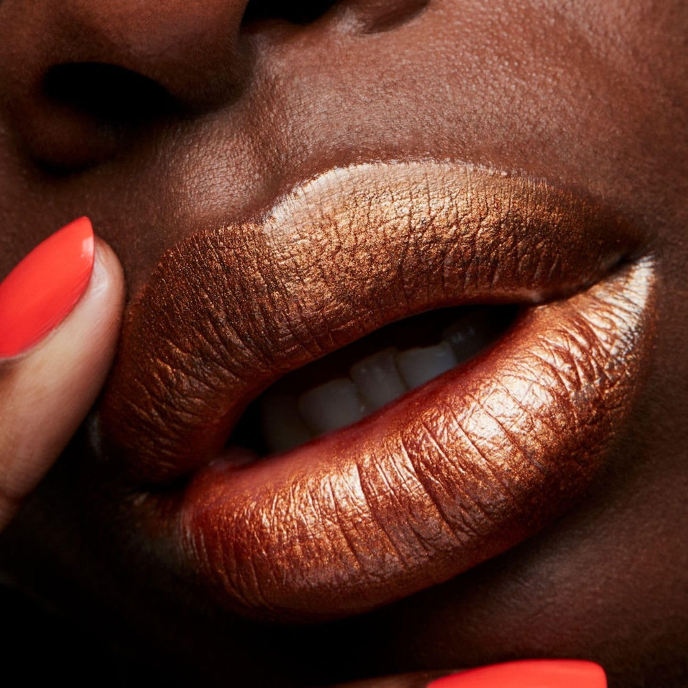 MAC Frost Lipstick Bronze Shimmer swatch on skin reveals a high pearl sheen.