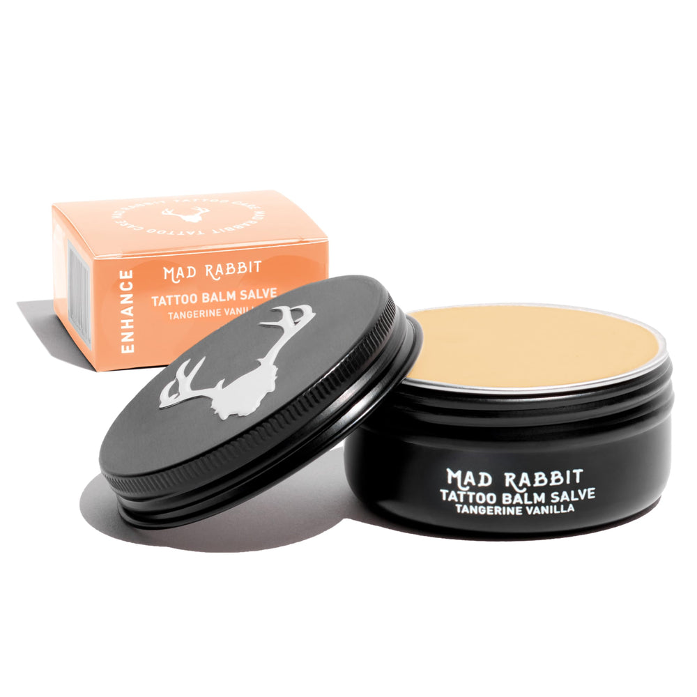 Mad Rabbit Tangerine & Vanilla Balm Salve tube application boosts hydration for tattoos.