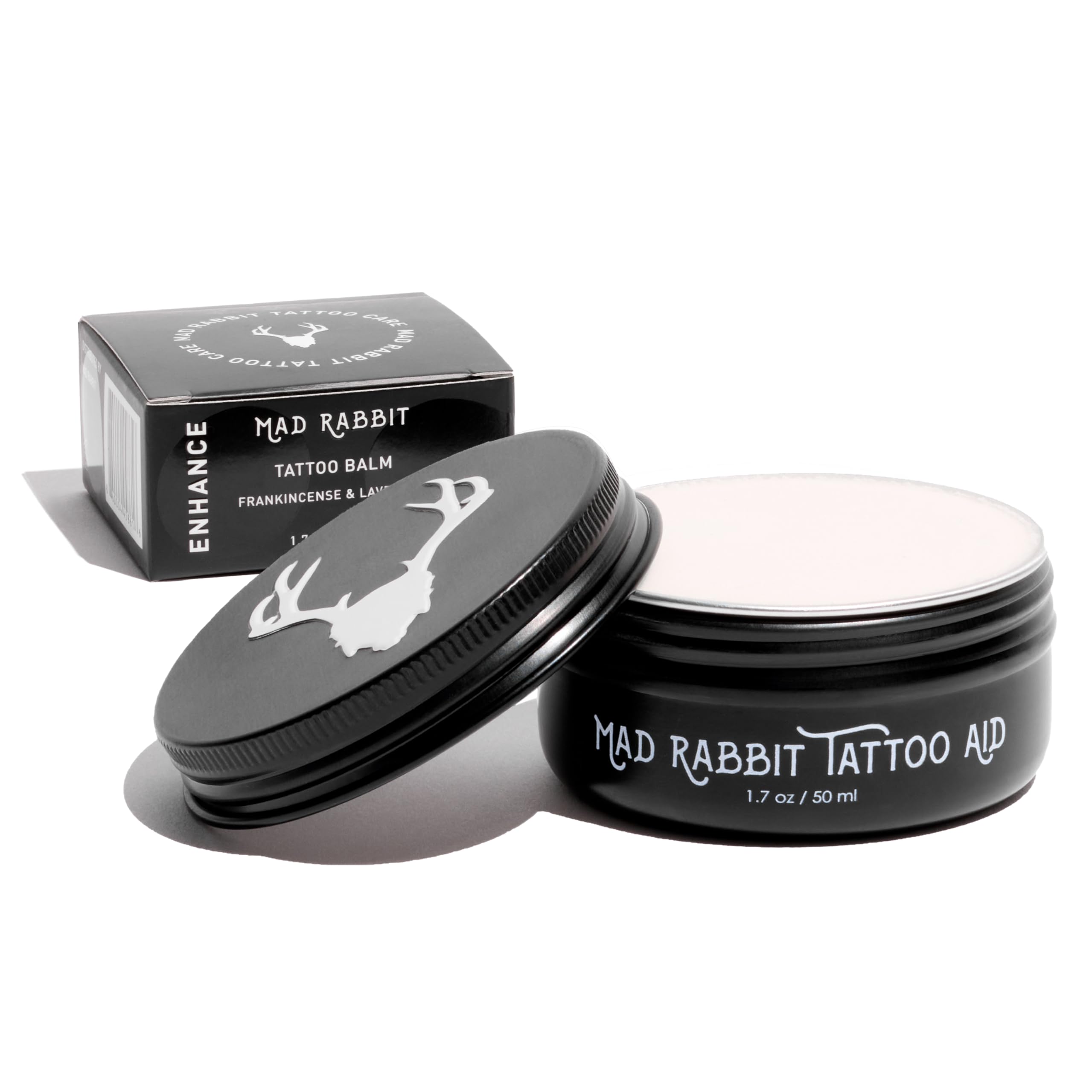 Mad Rabbit Tattoo Balm scoop being warmed for easy hydration of a new tattoo