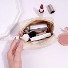MAGEFY beige leather mini bag with zip keeps cosmetics secure.